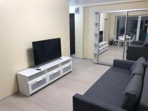 a living room with a flat screen tv and a couch at IKEA Home in Berehove