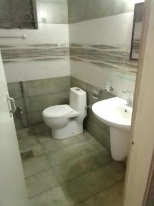 a bathroom with a toilet and a sink at Newly Renovated GuestHouse in Islamabad