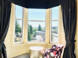 a room with a window, a toilet and a window at The Lovat Hotel in Perth