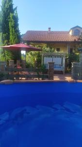a house with a swimming pool and a patio at B&B Naturin - Vegan Eco Farm in Lauriano
