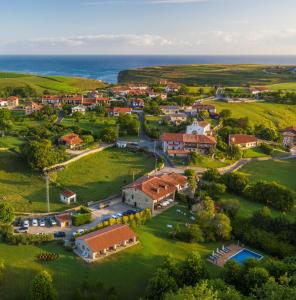 an aerial view of a home with the ocean in the background at Palación de Toñanes in Toñanes