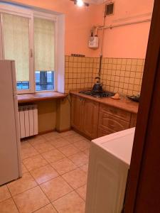 a kitchen with a sink and a stove top oven at Апартаменти з усіма зручностями in Chernivtsi