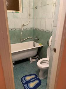 a bathroom with a tub and a toilet and a sink at Апартаменти з усіма зручностями in Chernivtsi