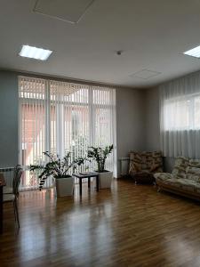 a living room with a couch and a table with plants at Sunny Harbour in Novorossiysk