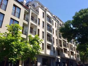 a large white building with trees in front of it at Central Flat & Free Parking in Varna City