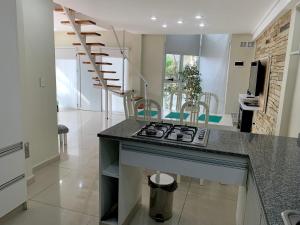 a kitchen with a counter and a stove top oven at BRISAS DEL MAR in Santa Teresita +7 photos