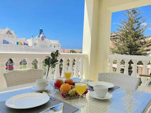 a table with a bowl of fruit on a balcony at Ocean Golf & Country Club J&K in San Miguel de Abona
