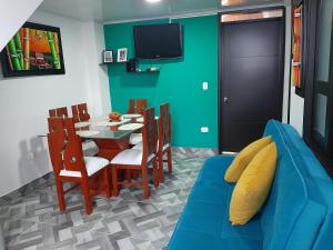 un salon avec un canapé bleu et une table dans l'établissement Apartamento Refugio Cafetero, à Santa Rosa de Cabal
