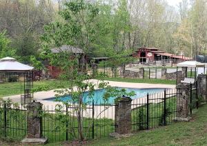 a fence with a swimming pool in a yard at Forrest Hills Mountain Resort in Dahlonega