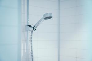 a shower head in front of a window at Å-Hamna Rorbuer in Å +106 photos