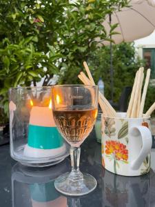 a glass of wine sitting on top of a table at Casa Santo António in São Brás de Alportel