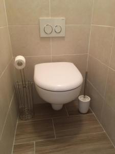 a bathroom with a white toilet in a room at Val Thorens - Confortable Appartement 4 personnes in Val Thorens