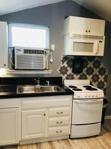 a kitchen with a sink and a microwave at Loft Guest Suite 1 Bedroom in Charleston