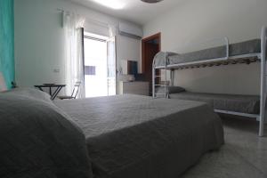 a bedroom with two bunk beds and a window at sognandocasab&b tortora in Praia a Mare +25 photos