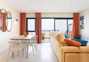 a living room with a couch and a table at Sunny Castillo Apartment in Costa de Antigua