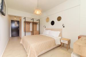 a bedroom with a large bed and a night stand at Hotel Pericles in Sami