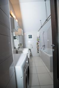 a bathroom with two sinks and a washing machine at Apartament Vlad in Turda +42 photos