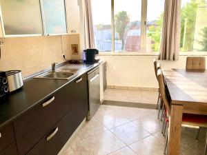 a kitchen with a sink and a counter top at Appartement Tavira in Tavira