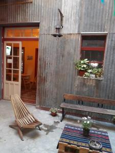 een patio met een bank, een tafel en een deur bij CASA ARTIGAS Hostel in Cordoba