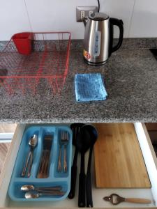 a kitchen counter with a blue tray with utensils at Depto.Barcelona Rucakawi in Temuco