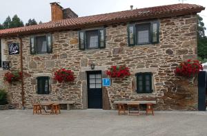 a stone building with tables in front of it at LAST 12K in Santiago de Compostela