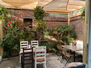 a patio with a table and chairs and plants at The Lemon Leaf Café Bar and Townhouse in Kinsale
