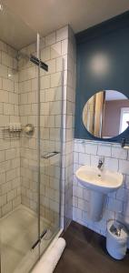 a bathroom with a glass shower and a sink at The Lemon Leaf Café Bar and Townhouse in Kinsale