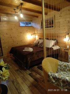 um quarto com uma cama e uma cadeira num quarto em Rancho do Xaxim - Gramado em Gramado