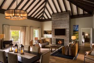 a living room with a table and a fireplace at La Cantera Resort & Spa in San Antonio