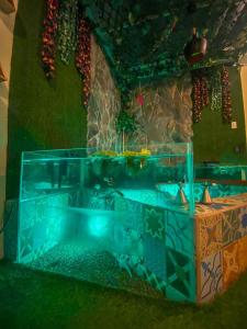 a fish tank in the corner of a room at Cosmos Chill - Suite con jacuzzi y acuario in Ambato