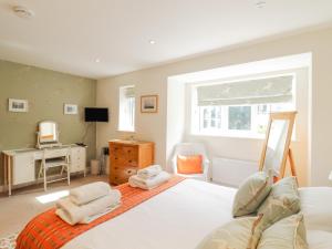 a bedroom with a white bed and a desk at Kinsale in Broadstairs