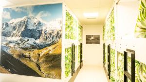 a hallway with a mountain mural on the wall at Hostel Playa de Merón in San Vicente de la Barquera
