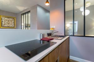 a kitchen with a sink and a counter top at Host inn Lyon - Hypercentre Vieux Lyon in Lyon