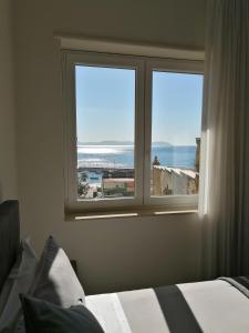 a bedroom with a window with a view of the ocean at Napoli d'Amare B&B in Naples