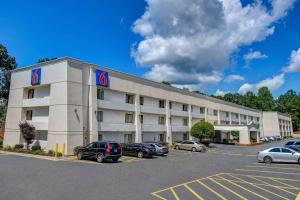 a hotel building with cars parked in a parking lot at Motel 6-Norcross, GA in Norcross