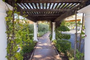 a walkway under a pergola on a house at Best Western Plus Dixon Davis in Dixon