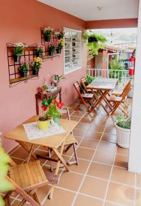 a patio with tables and chairs and potted plants at Piccola Pousada in Águas de São Pedro