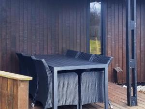 a blue table and chairs on a deck at 4 person holiday home in Slagelse in Slagelse