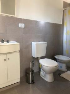 a bathroom with a toilet and a sink at Cabañas Don Eduardo in Mina Clavero