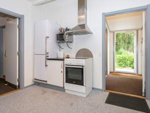 a kitchen with a stove and a refrigerator at 20 person holiday home in Herning in Herning