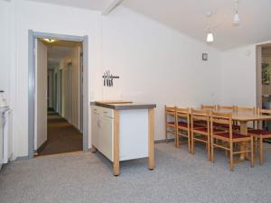 a kitchen and dining room with a table and chairs at 20 person holiday home in Herning in Herning