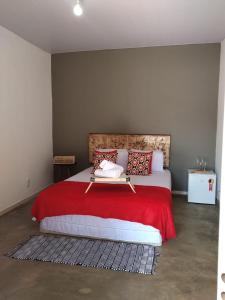 En eller flere senge i et værelse på Sítio Aroeira Chalés
