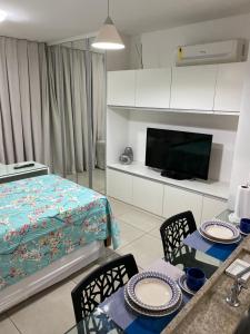 a living room with a bed and a table and chairs at Golden Shopping Home Service in Recife +57 photos