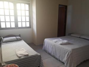 a bedroom with two beds with towels on them at Casa na Praia dos Carneiros - Tamandaré in Tamandaré +17 photos