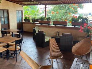 a restaurant with tables and chairs on a patio at Flor de Cera in Tepoztlán