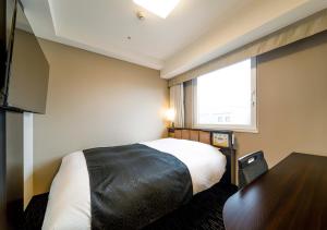 a hotel room with a bed and a window at APA Hotel Hakata Ekimae 2Chome in Fukuoka +37 photos