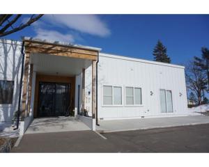 a large white building with a large door at Sarabetsu-mura chiiki Kouryu Center - Vacation STAY 21683v in Naka-satsunai
