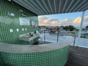 a building with a bench on a balcony with a view at Israel Flat Tambaú in João Pessoa