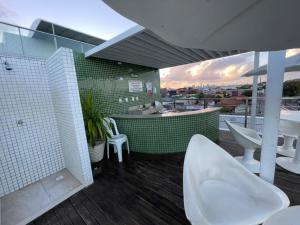 a bathroom with white toilets and a view of a city at Israel Flat Tambaú in João Pessoa