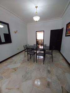 a dining room with a table and chairs at Del Sol Suites - Apartamento Familiar in Guayaquil +18 photos